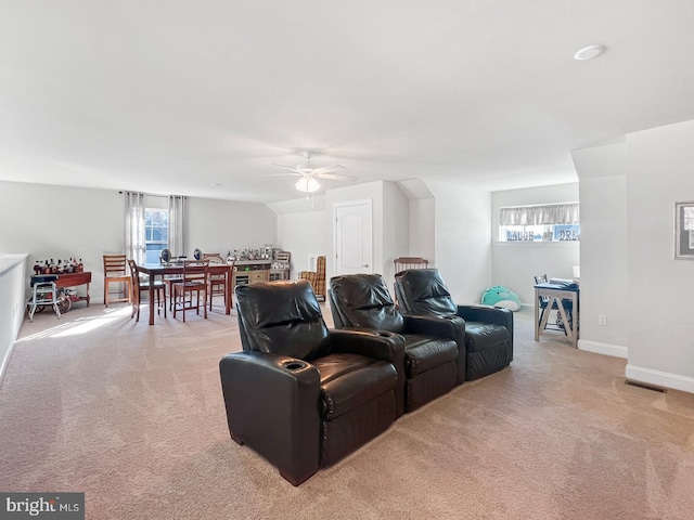 interior space featuring ceiling fan and light colored carpet