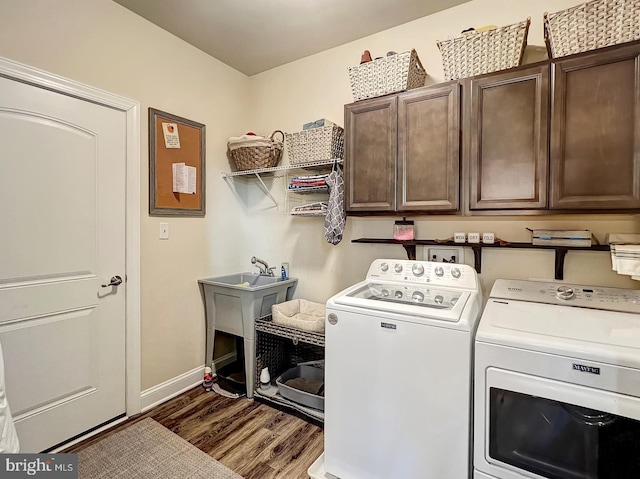 laundry area with cabinets, dark wood-type flooring, and independent washer and dryer