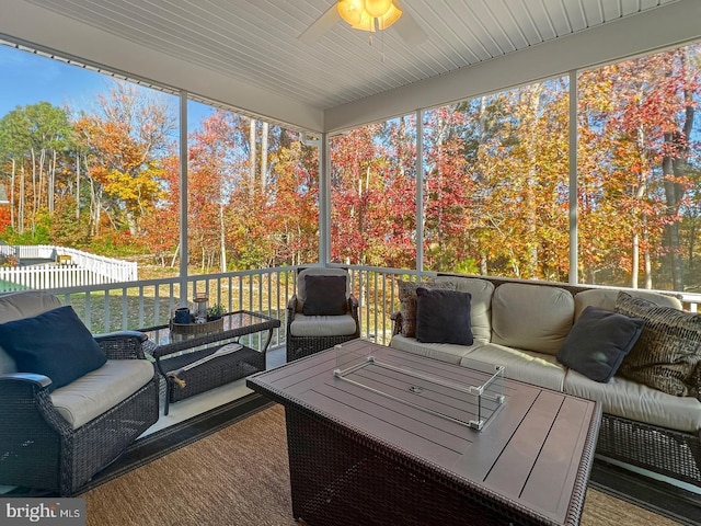 sunroom / solarium featuring ceiling fan