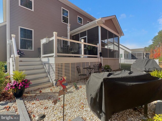 back of property with a sunroom