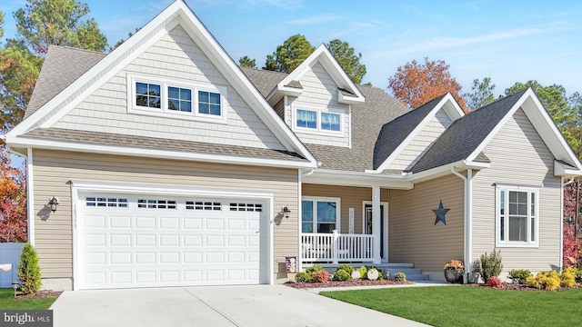 craftsman-style house featuring a garage, a front lawn, and covered porch