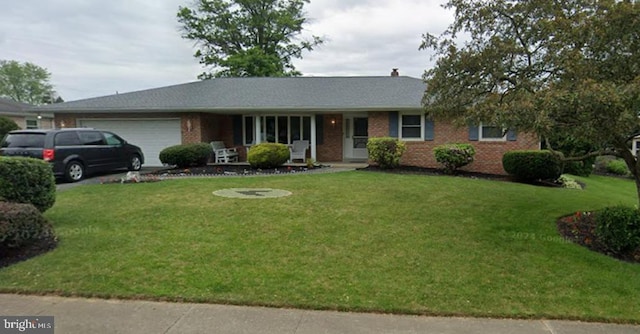 ranch-style house with a garage and a front yard