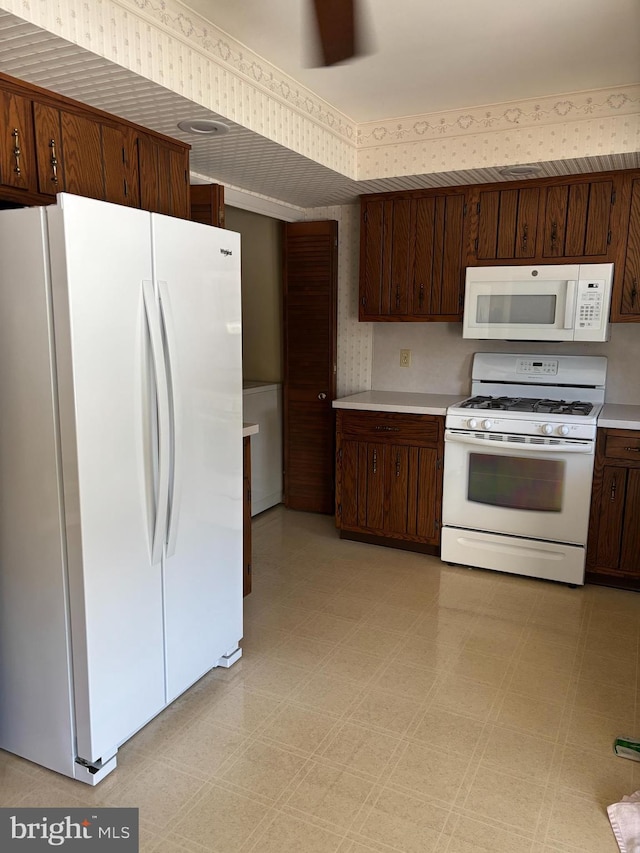 kitchen with white appliances and dark brown cabinets