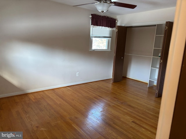 unfurnished bedroom with ceiling fan, hardwood / wood-style floors, and a closet