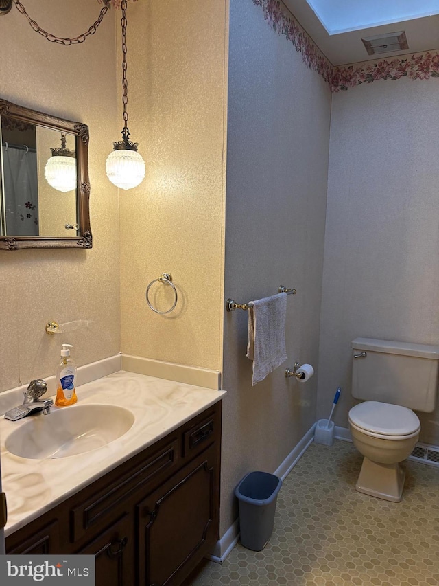 bathroom with vanity and toilet