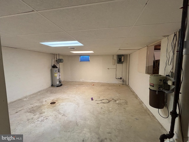 basement featuring gas water heater, a drop ceiling, and electric panel