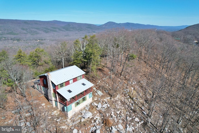 aerial view featuring a view of trees and a mountain view