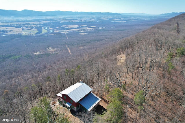 aerial view featuring a mountain view and a wooded view