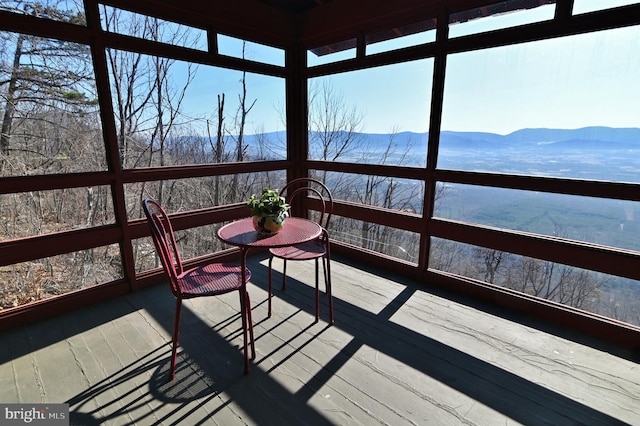 unfurnished sunroom featuring a mountain view