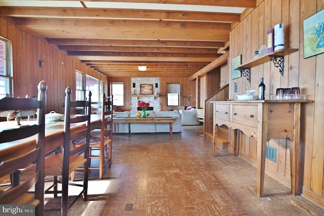 kitchen featuring beam ceiling, visible vents, wood walls, and open shelves