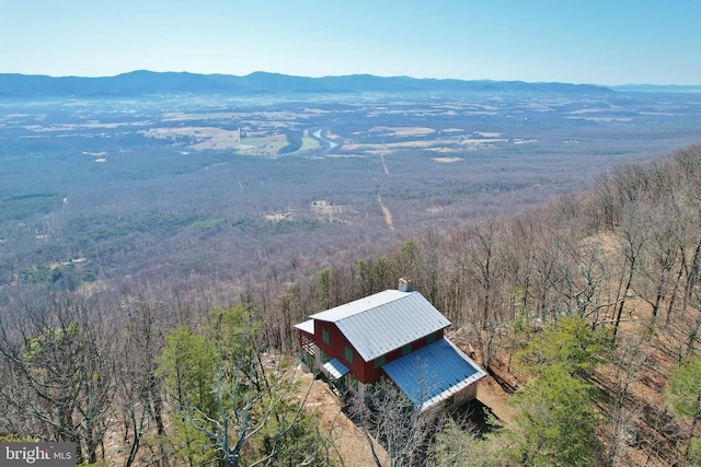 birds eye view of property with a mountain view and a wooded view