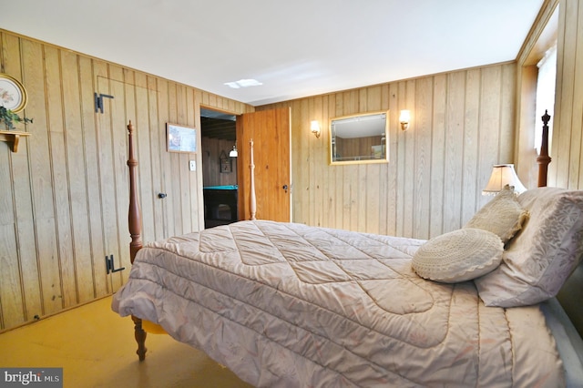 bedroom featuring wood walls and carpet flooring