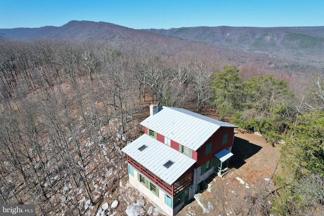 birds eye view of property with a mountain view and a wooded view