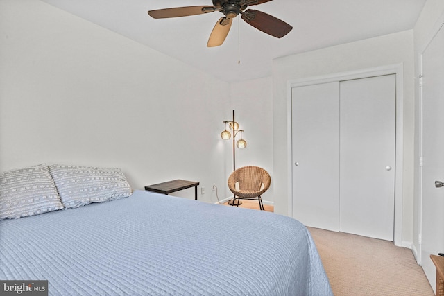 bedroom featuring a closet, light carpet, and ceiling fan