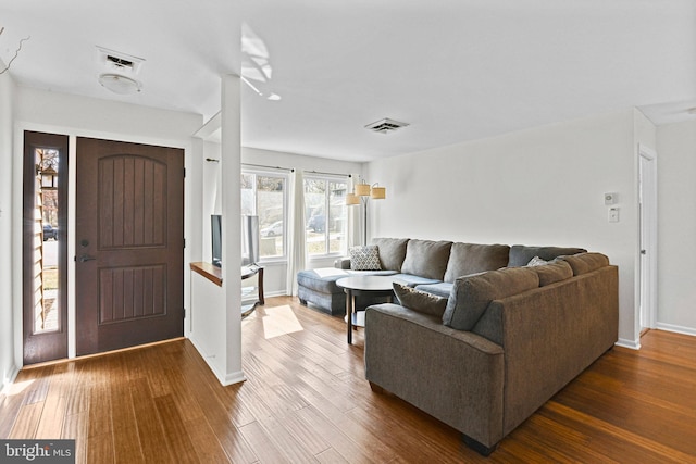 living room with visible vents and dark wood-type flooring