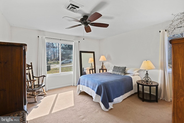 bedroom featuring light carpet, baseboards, visible vents, and ceiling fan