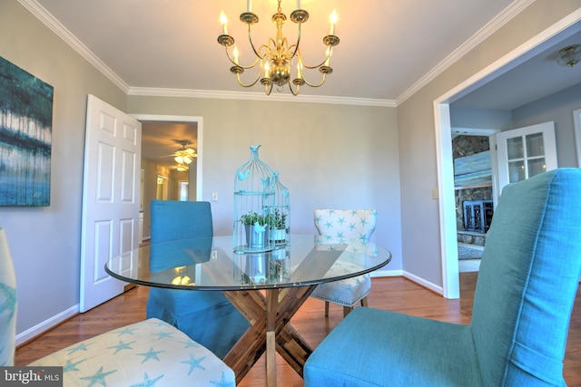 dining room featuring baseboards, a chandelier, wood finished floors, and ornamental molding