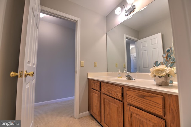 bathroom with baseboards and vanity