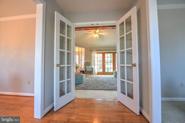 doorway with french doors, baseboards, and wood finished floors