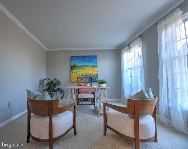 living area with baseboards, crown molding, and light colored carpet