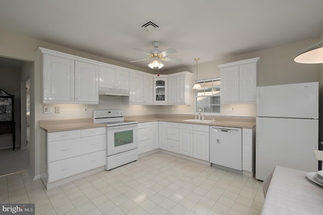 kitchen with white cabinetry, white appliances, sink, and hanging light fixtures