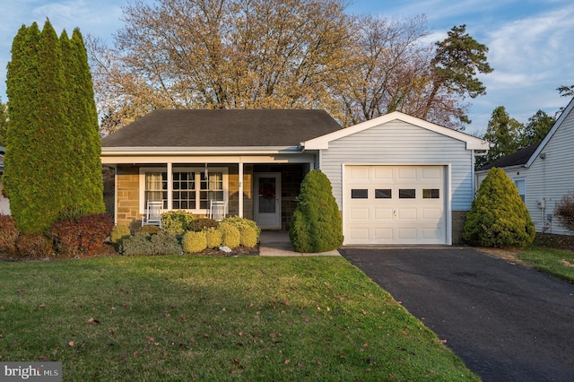 single story home with a garage and a front lawn