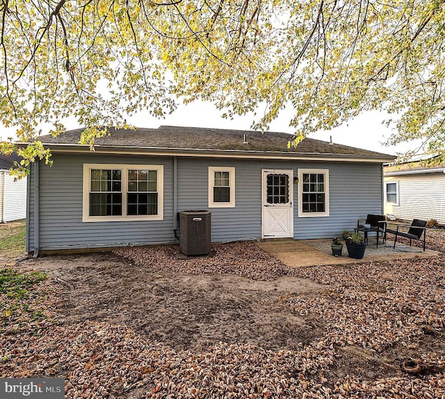 rear view of property featuring central air condition unit and a patio area