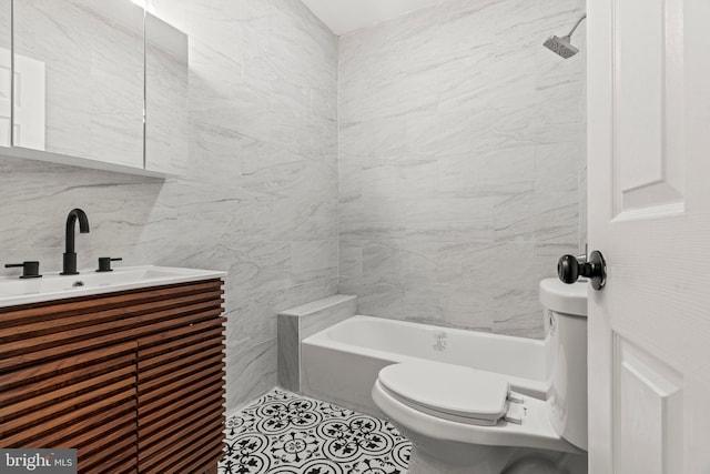 bathroom featuring vanity, tile walls, and toilet