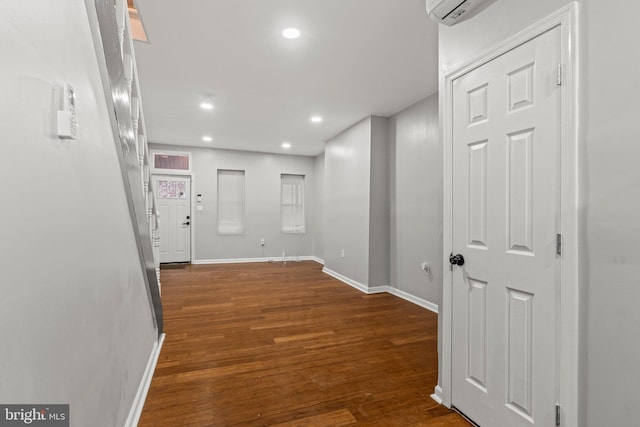 hall featuring a wall mounted air conditioner and dark hardwood / wood-style floors