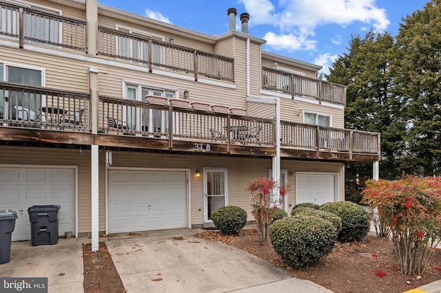 rear view of property with driveway and an attached garage