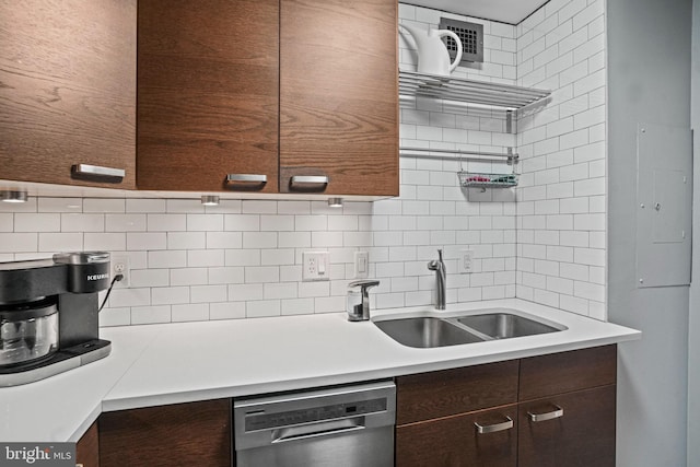 kitchen featuring sink, dishwasher, dark brown cabinetry, and backsplash