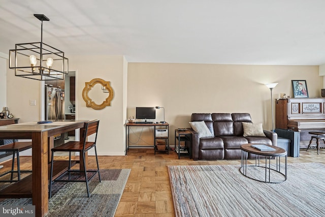 living room with light parquet flooring and a chandelier