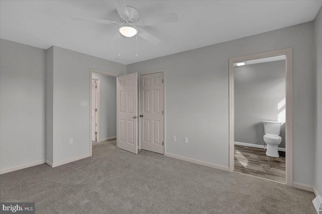 unfurnished bedroom featuring a ceiling fan, light colored carpet, baseboards, and ensuite bathroom