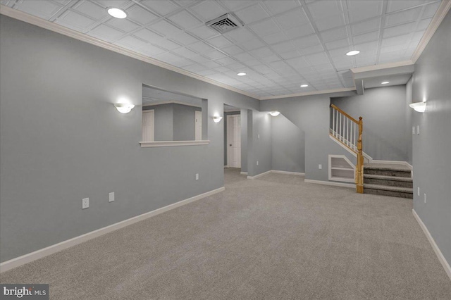 finished below grade area featuring carpet, visible vents, stairway, ornamental molding, and baseboards