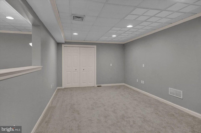 empty room with carpet, visible vents, and baseboards