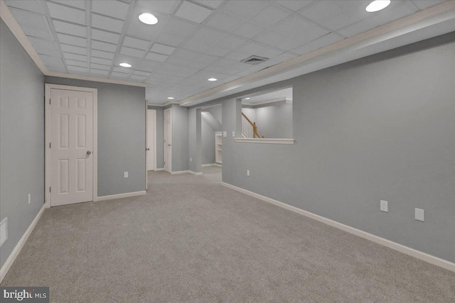 finished basement with light carpet, baseboards, visible vents, a paneled ceiling, and recessed lighting