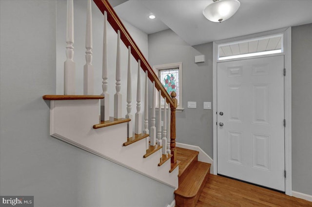 foyer entrance featuring light wood finished floors and baseboards