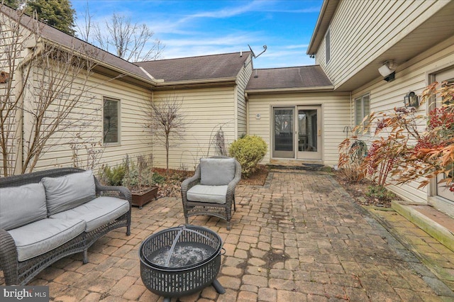 view of patio / terrace with an outdoor living space with a fire pit