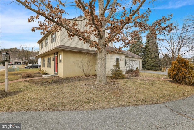 view of property exterior with a garage, a yard, and stucco siding