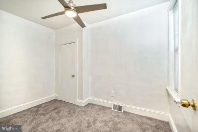 unfurnished room with visible vents, ceiling fan, baseboards, and carpet floors