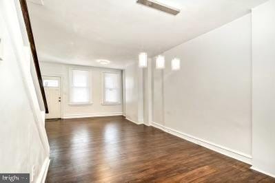 spare room featuring dark wood-type flooring