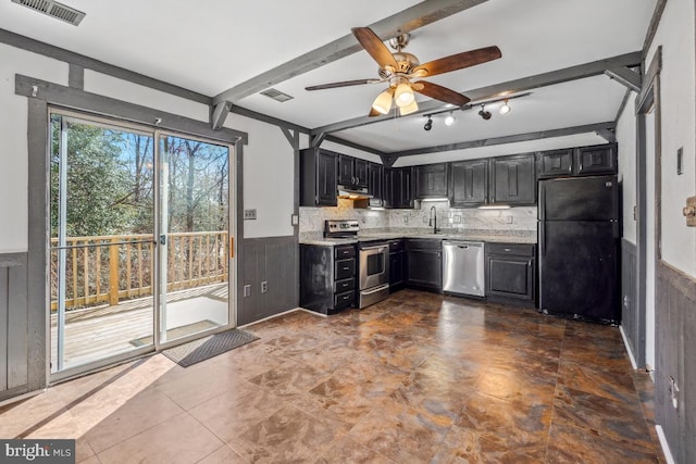 kitchen featuring visible vents, a wainscoted wall, range hood, stainless steel appliances, and dark cabinets