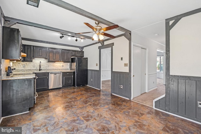 kitchen featuring stainless steel dishwasher, beam ceiling, a wainscoted wall, and freestanding refrigerator