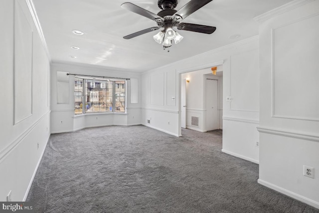 carpeted spare room featuring ceiling fan, baseboards, and ornamental molding