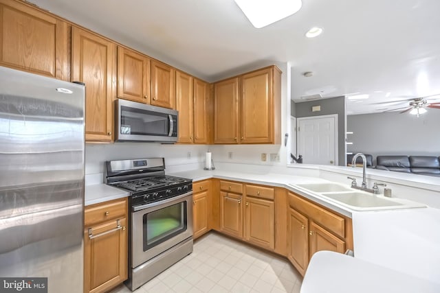 kitchen featuring recessed lighting, ceiling fan, a sink, light countertops, and appliances with stainless steel finishes