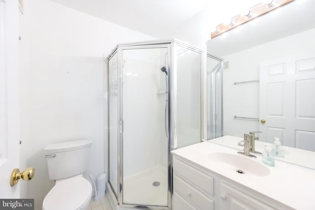 bathroom featuring a shower stall, toilet, and vanity