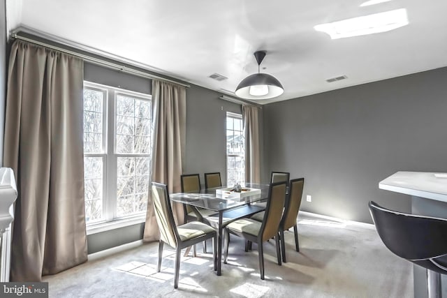 dining space featuring visible vents, carpet flooring, and baseboards