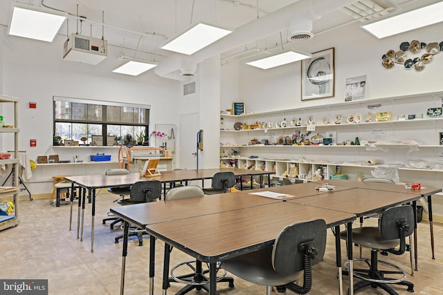 dining area with a high ceiling and visible vents