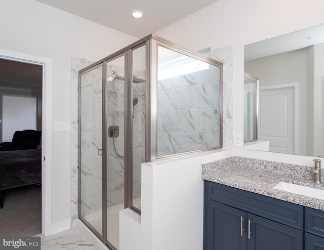 bathroom featuring an enclosed shower and vanity