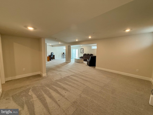 basement featuring light carpet